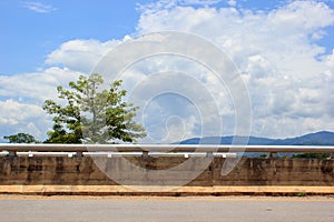 Side of road with tree and clouds sky background