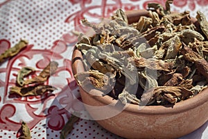 Side shoot of traditionally dried under sun string beans on small olla with spreaded vegetables.