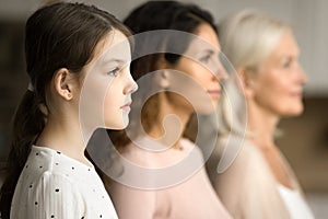 Side shot of little child girl with mom and grandmother
