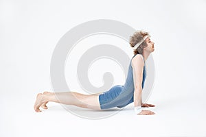 Side shot of nice retro guy practicing yoga, isolated on white