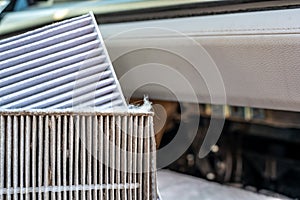 Side-by-side comparison of a dirty and clean automotive cabin filter