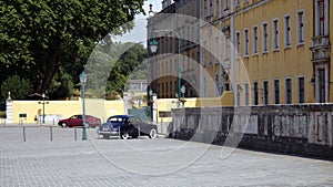 Side square north of the Mafra Palace, dark blue Jaguar Mark IX in the foreground, Portugal