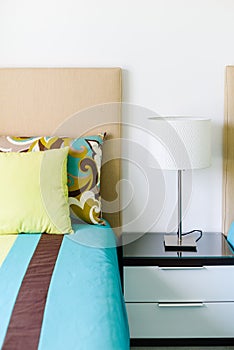 Side table with white lamp in the bedroom