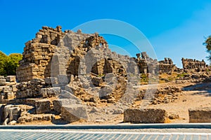 SIDE, TURKEY: Ancient ruins and a road in the city of Side on a sunny summer day.