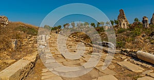 SIDE, TURKEY: Ancient ruins and a road in the city of Side on a sunny summer day.