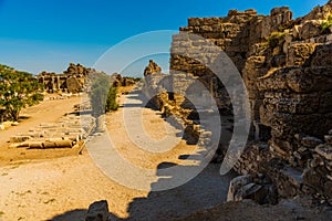 SIDE, TURKEY: Ancient ruins and a road in the city of Side on a sunny summer day.