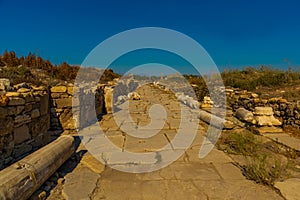 SIDE, TURKEY: Ancient ruins and a road in the city of Side on a sunny summer day.