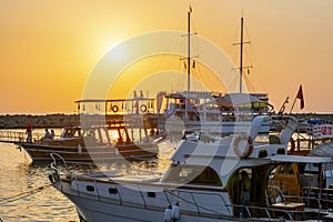 Side, Turkey - September 2021: Ships and boats in Side port at sunset