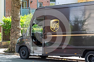 the side of a UPS delivery van parked on a street while delivering