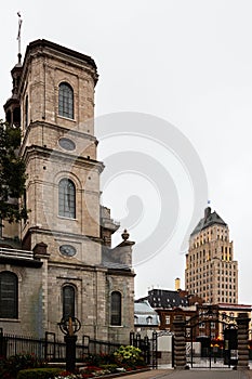Side view of the 1759 Cathedral-Basilica of Notre-Dame de Québec, with the 1930 art deco Price building in the background,