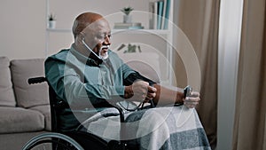 Side view African old 60s male ill senior retired bald man with gray beard measuring blood pressure with electronic