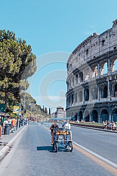 Side view of the Ancient Roman Colosseum, Rome, Italy. Colosseum and tourists in summer day for poster, calendar, post