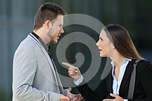 Couple of executives arguing on the street photo