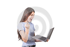 Side view of an angry woman holding a laptop in her hand, isolated on white background. Irritated freelancer girl yelling at her