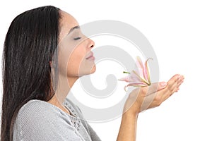 Side view of an arab woman smelling a flower