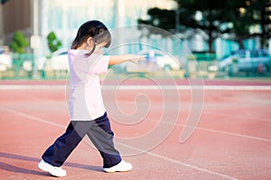 Side view of Asian cute girl`s is stretching her arms in front of her to act like a zombie or ghost.