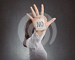 Side view of asian woman showing NO note on her hand