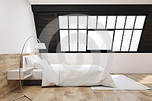 Side view of an attic bedroom with a carpet, light