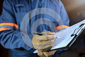 Side view, an auditor or specter holding a clipboard and checklist photo