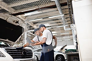 Side view of auto mechanic holding