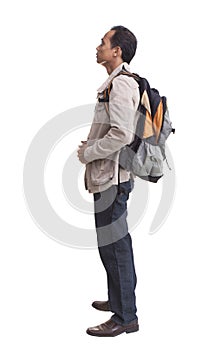 Side view of backpacker standing on white