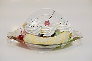 Side view Banana Split Ice Cream in a boat shaped glass cup on white table background,white background,food, copy space