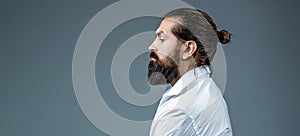 Side view bearded man isolated on gray background. Man's haircut in barber shop. Side view portrait of stylish young