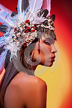 Side view of beautiful naked woman in tribal headdress