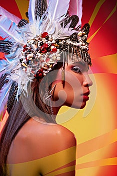 Side view of beautiful naked woman in tribal headdress