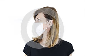 Side view of beautiful woman wearing medical face mask because of air, isolated on white background, copy space. Studio shot.