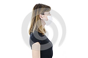 Side view of beautiful woman wearing medical face mask because of air, isolated on white background, copy space. Studio shot.