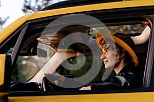 Side View of Beautiful Young Woman Driving Car