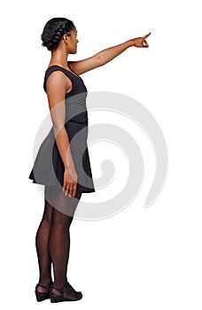 Side view of a black African-American woman in a brown dress poi