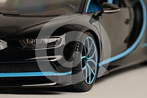 Side view of black Bugatti Chiron with blue trim toy car