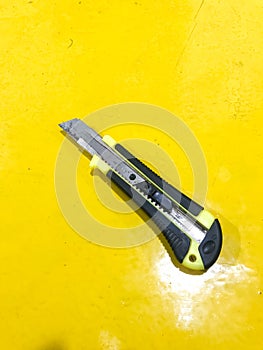 Side view of black yellow utility knife