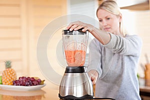 Side view of blender chopping fruits