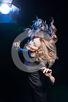 Side view of blonde woman with wild hair