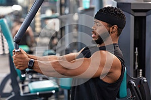 Side view of bodybuilder working out on pec deck machine