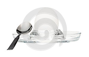 Side view of boiled egg and spoon in glass egg cup