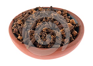 Side view of a bowl filled with cloves isolated on a white background