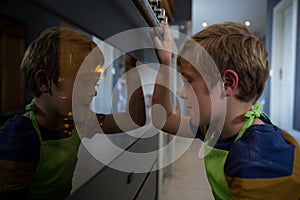 Side view of boy looking at oven