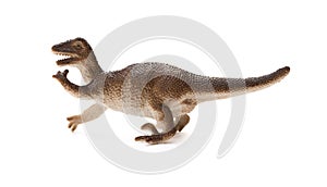 Side view brown plastic dinosaur toy on white background
