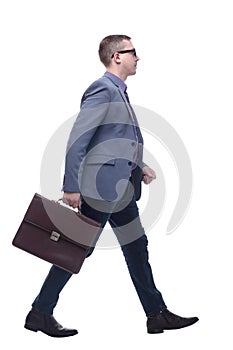 Side view business man holding brief case and walking