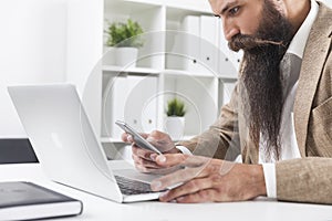 Side view of businessman with magnificent stache and his phone