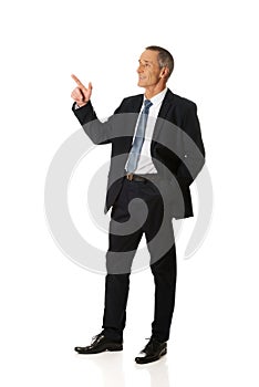 Side view businessman pointing upwards