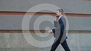 Side view businessman talking phone at street. Man talking phone with partner