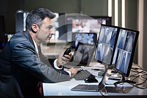 Side View Of A Businessman Talking On Walkie Talkie photo