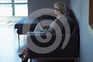 Side view of businesswoman using digital tablet