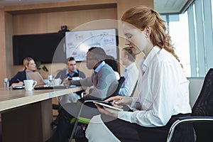 Side view of businesswoman using digital tablet at office