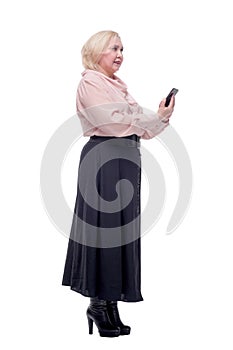 Side view of busy business woman in formal clothes typing on mobile phone